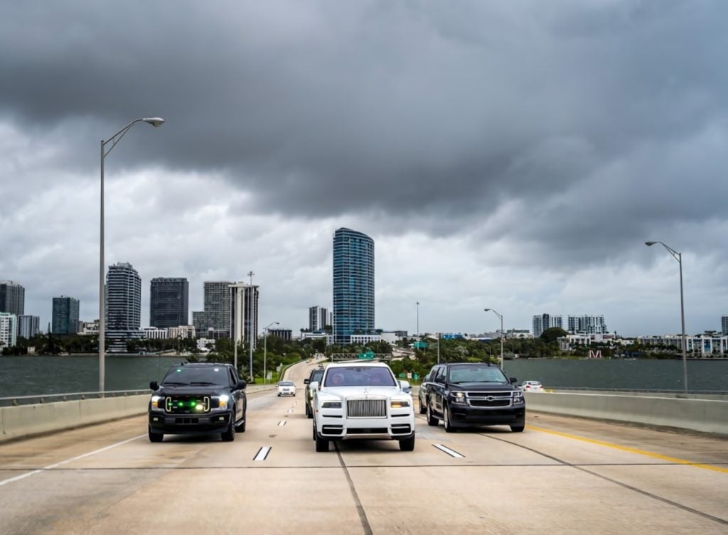 FSO Guard security vehicles escorting a client car on a Miami causeway
