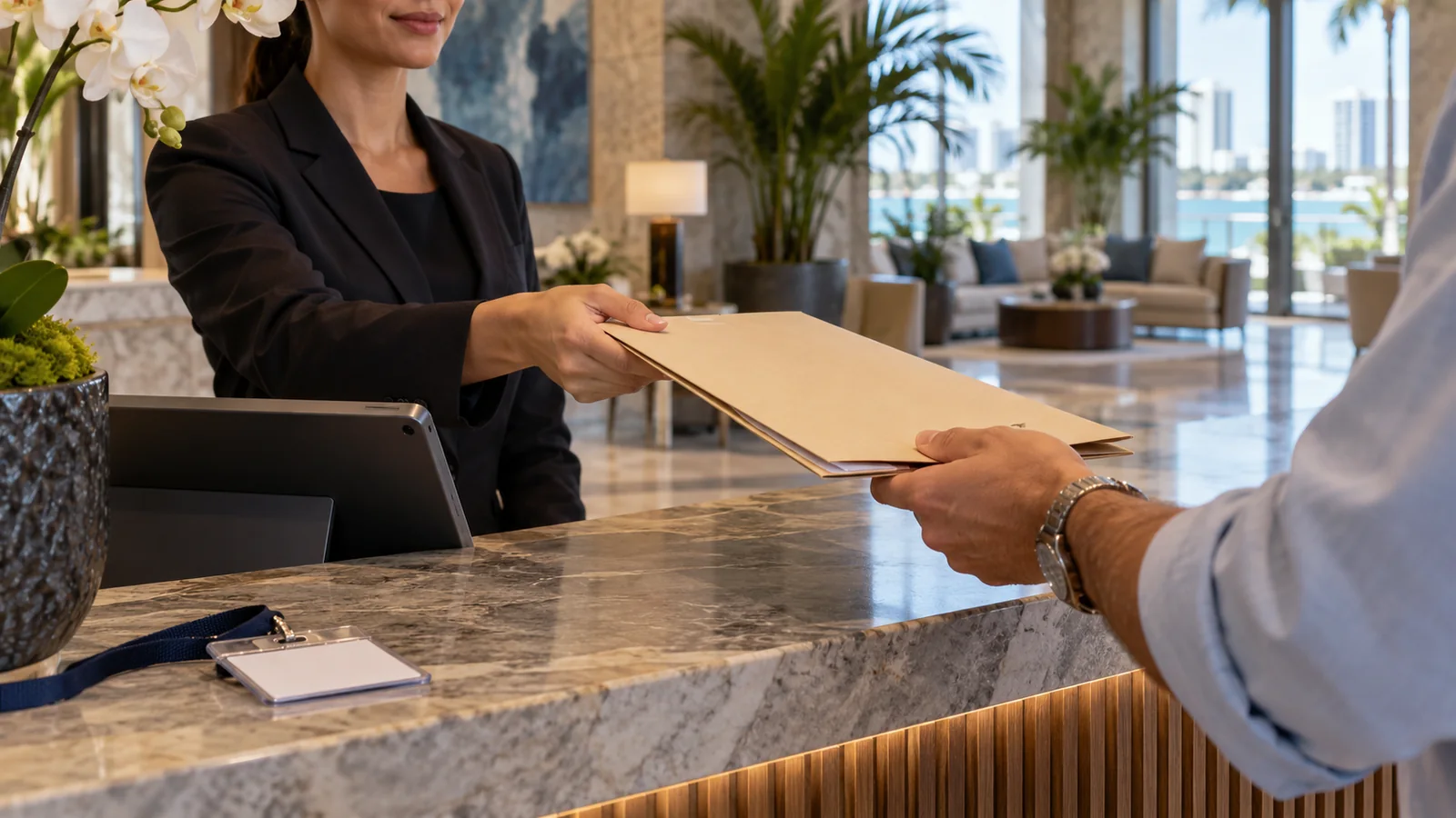 Visitor check-in desk with a folder, tablet and blank temporary badge